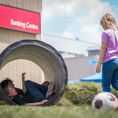 2 kids playing on artificial turf in downtown woodstock