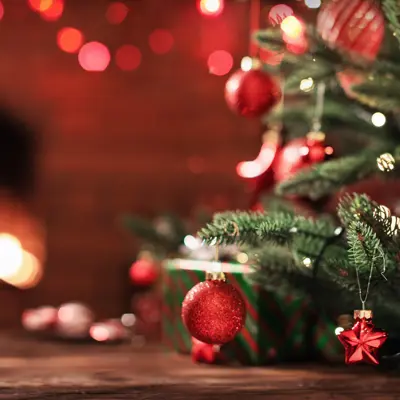 bottom of pine tree with red decorations 